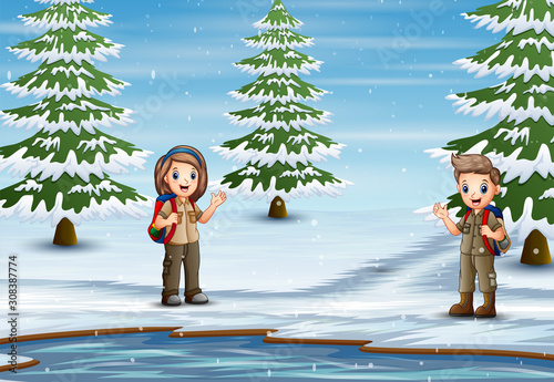 The scout exploring nature in winter landscape