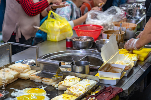 Local turnip cake vendor in Taichung Second Public Market. Old market has always been the favorite of backpack travellers, especially because of the food. Taichung, Taiwan photo