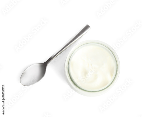 Tasty organic yogurt in glass jar and spoon isolated on white, top view