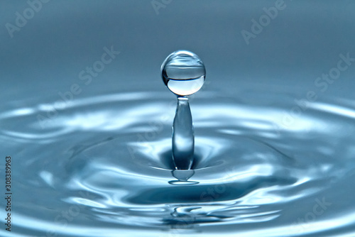 a drop of water hovering in the air before hitting a water surface, which will cause a beautiful splash, close-up photo