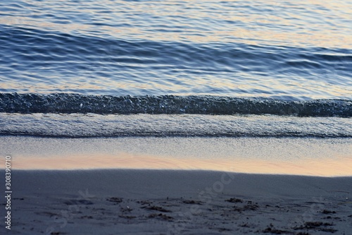 Fototapeta Naklejka Na Ścianę i Meble -  Abstract sea background/ Sea waves crashing on a sandy beach/ water surface background