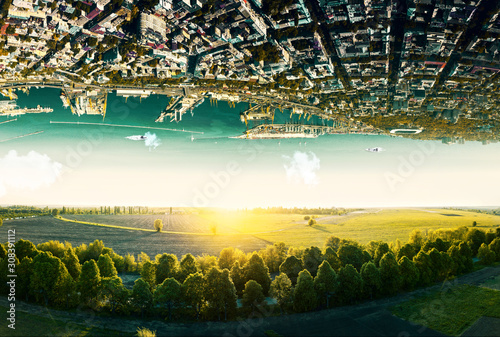 Natural landscape with unreal upside down sityscape.