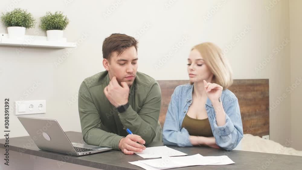 Beautiful family studies Bank loan documents on laptop, combines the management of financial expenditure Beautiful family studies Bank loan documents on laptop, combines the management of financial expenditure