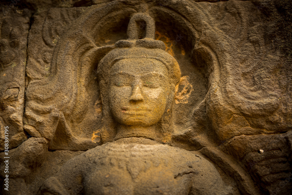 praying buddah in aisa, close up of a sculpture with the hand and smiling face 