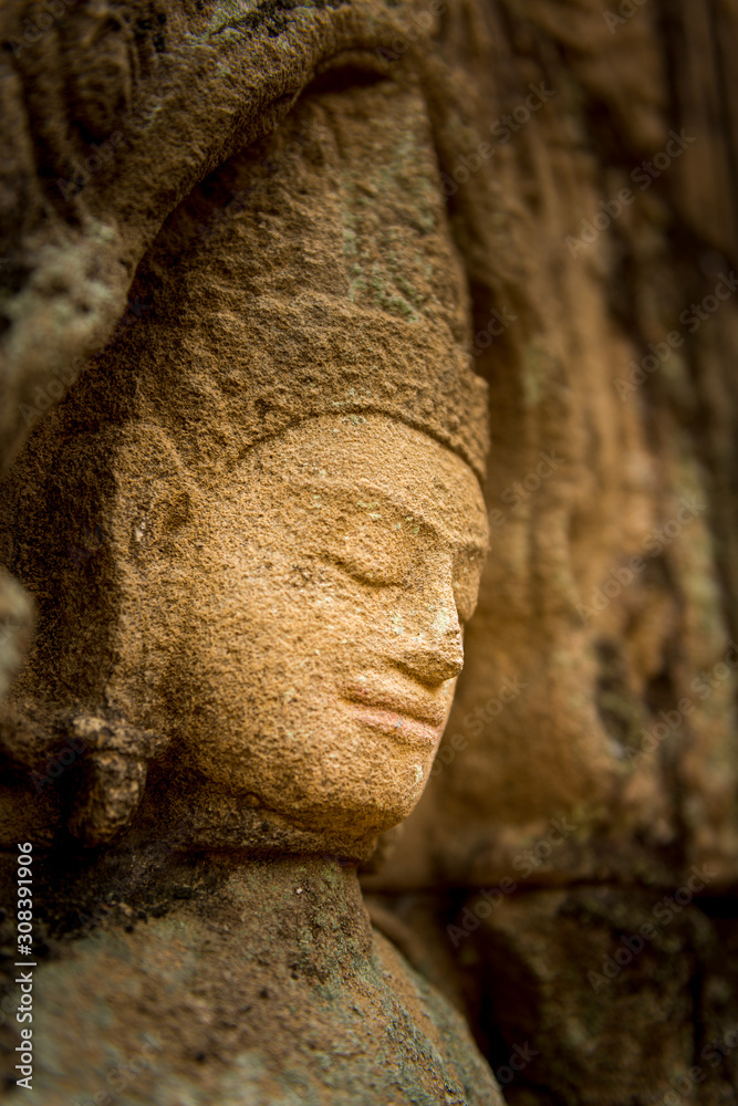 praying buddah in aisa, close up of a sculpture with the hand and smiling face 