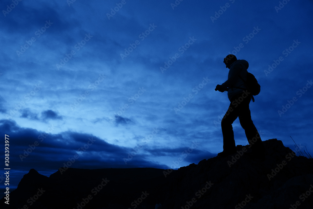 Silhouette of a person on the sky background.