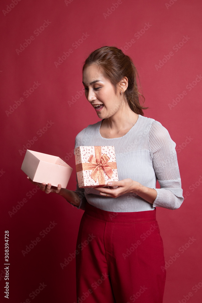 Young Asian woman open a gift box. Young Asian woman open a gift box.