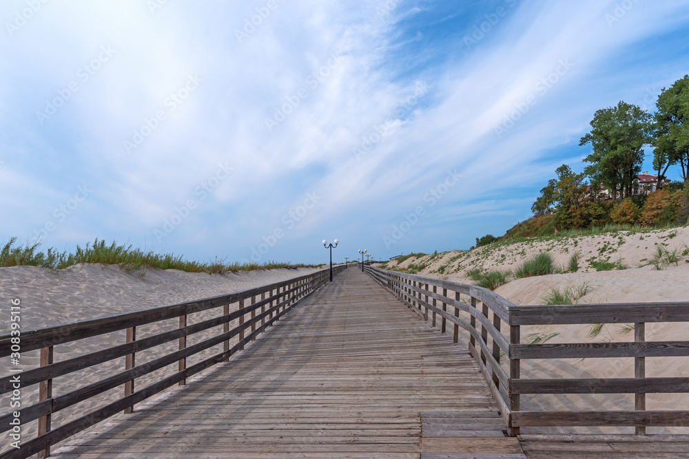 Wooden promenade among sand dunes along the Baltic Sea