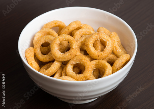 Fried onion snacks in white bowl. 