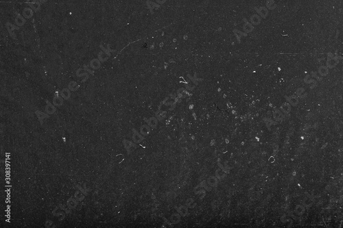 Black dusty abstract background. Old black film paper texture. Grungy textured blackboard.