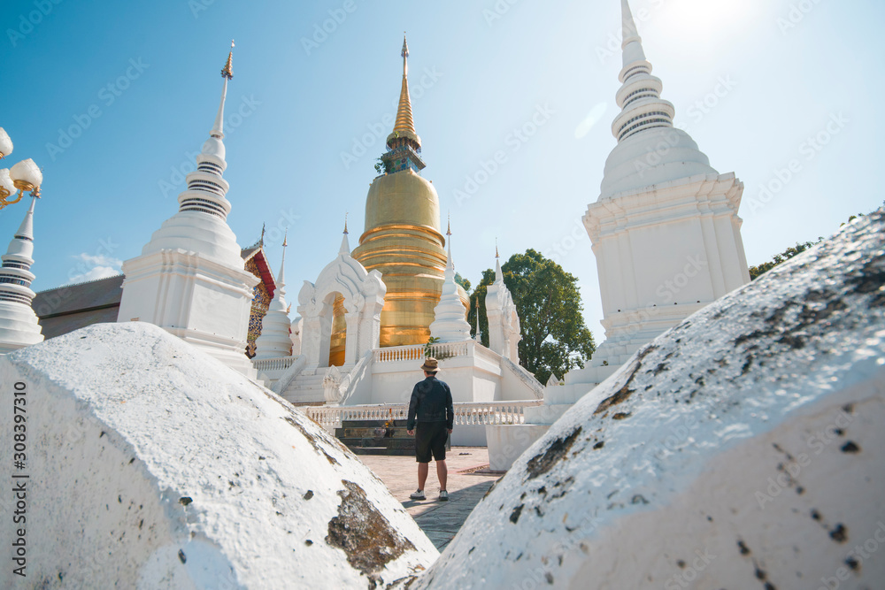 A man tourist is visiting and sightseeing at Wat Suan Dok in Chiangmai, Thailand.