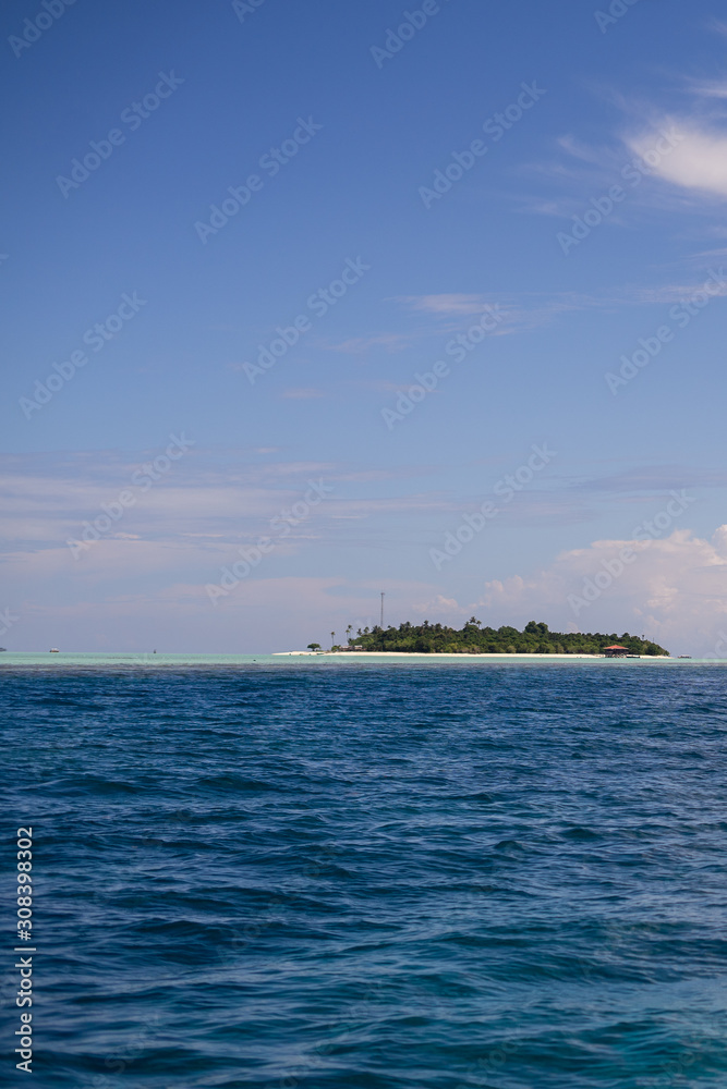 Dark blue and turquoise green with small island in Semporna, Borneo, Sabah.