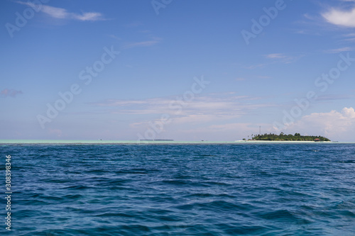 Dark blue and turquoise green with small island in Semporna, Borneo, Sabah.