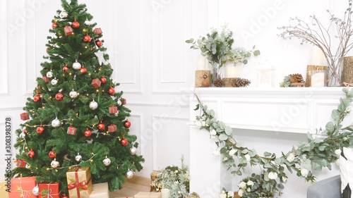 Christmas tree decorated holiday winter xmas celebration present gift to family decorate with ornament golden ball in cozy living room. Merry Christmas and happy new year festival traditional concept. photo