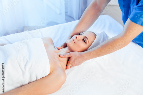 girl masseur doing massage in spa health photo
