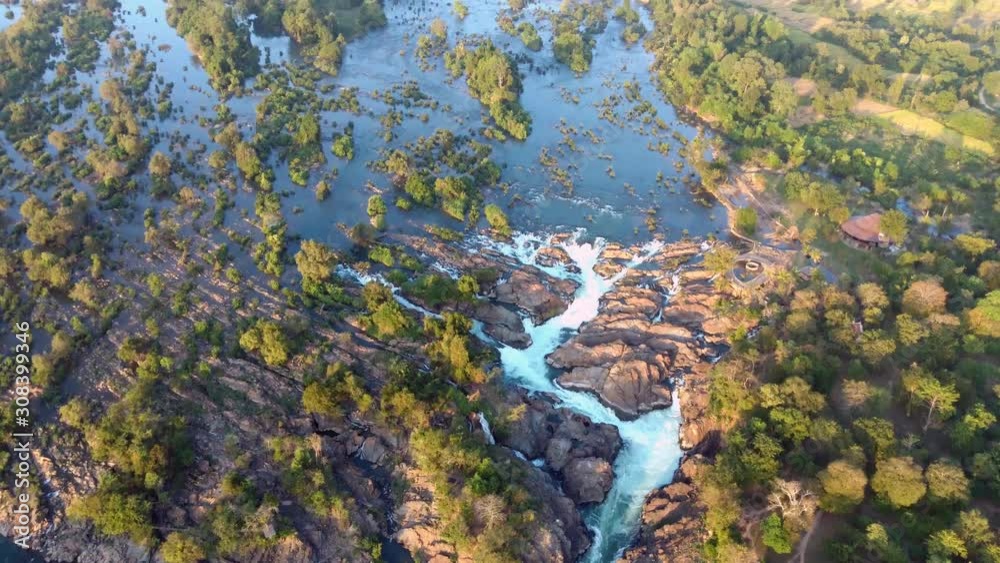 Four Thousand Islands In Mekong, Laos - Beautiful Scenery Of Water Flowing In The Rocky Stream Fringed With Green Trees - Aerial Top Shot Four Thousand Islands In Mekong, Laos - Beautiful Scenery Of Water Flowing In The Rocky Stream Fringed With Green Trees - Aerial Top Shot