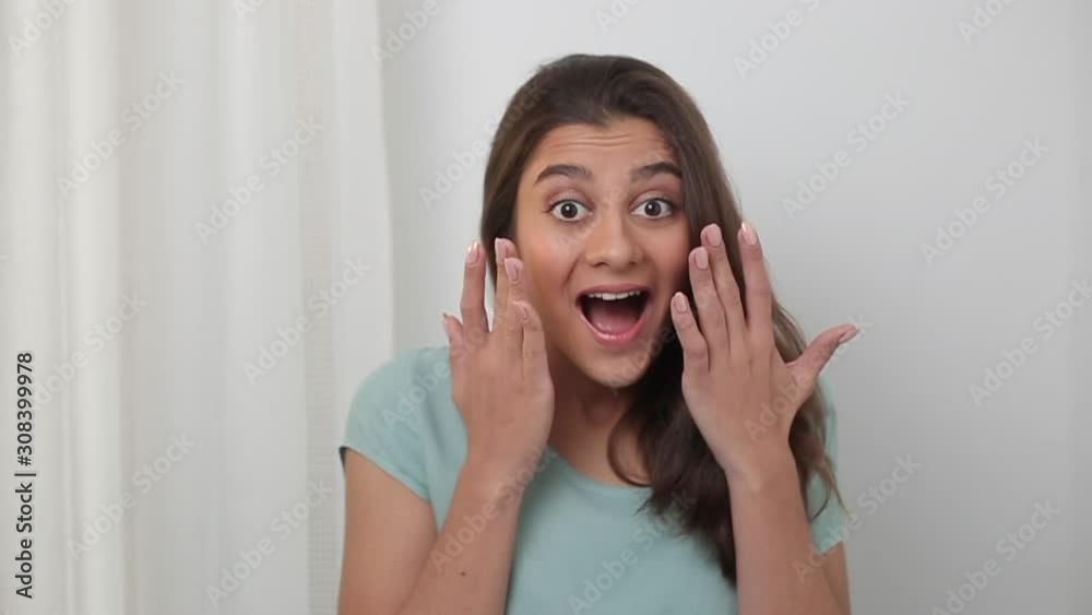 The shocking face of a young woman. Portrait of a joyful surprise girl. The shocking face of a young woman. Portrait of a joyful surprise girl.