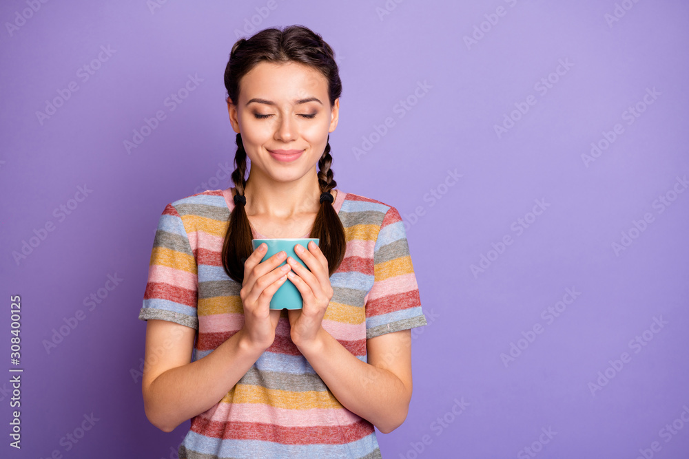 Photo of pretty cute lady holding hands cup hot beverage drink dreamer imagination flight eyes closed wear casual striped t-shirt isolated purple color background Photo of pretty cute lady holding hands cup hot beverage drink dreamer imagination flight eyes closed wear casual striped t-shirt isolated purple color background