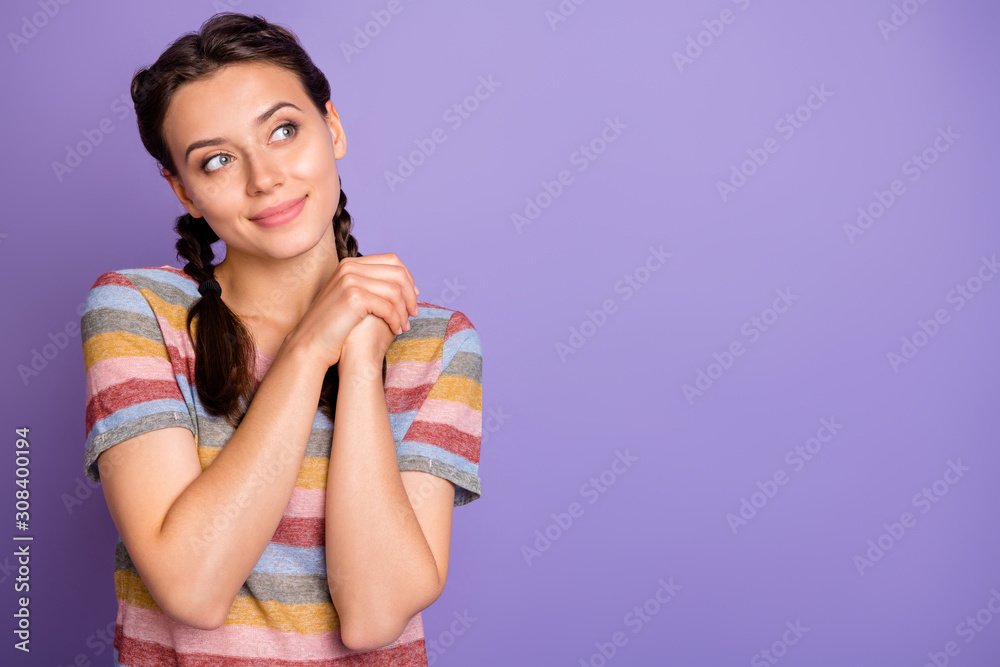 Photo of pretty cute lady holding hands together looking empty space dreamer imagination flight wear casual striped t-shirt isolated purple color background Photo of pretty cute lady holding hands together looking empty space dreamer imagination flight wear casual striped t-shirt isolated purple color background