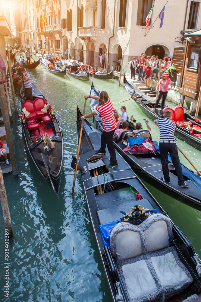 Gondolas with gondoliers in Venice