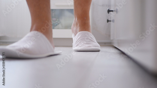 Man in the Bedroom with White Slippers in His Foots