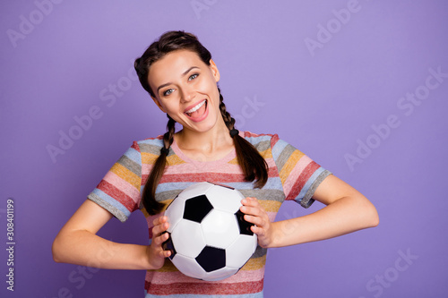 Close-up portrait of her she nice attractive lovely pretty cheerful cheery glad girl holding in hands black and white ball having fun isolated over lilac violet purple pastel background © deagreez