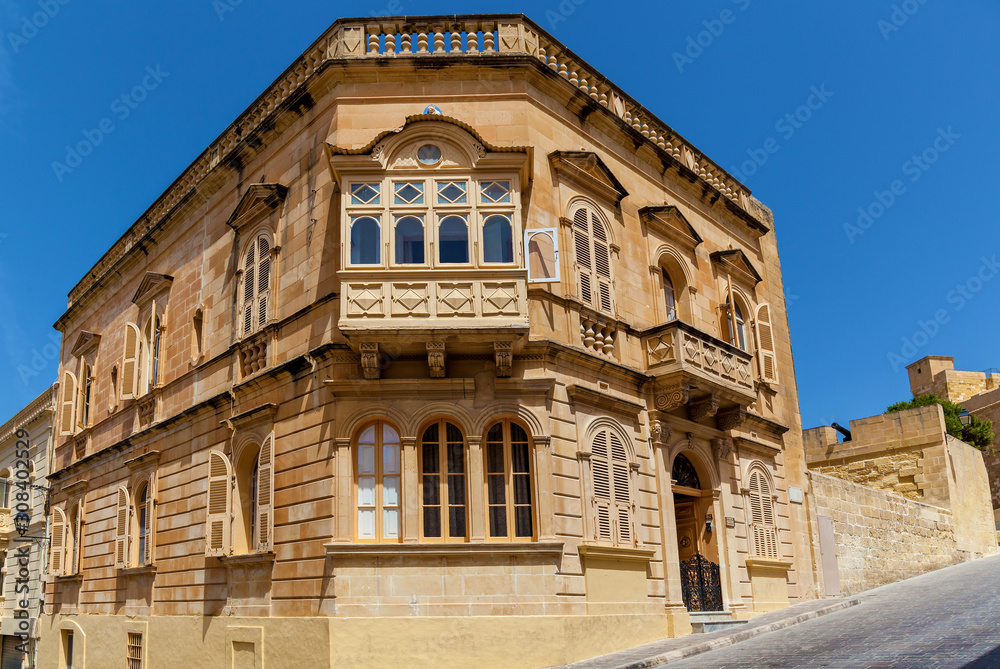 The old building is placed on the corner in Victoria town, Malta