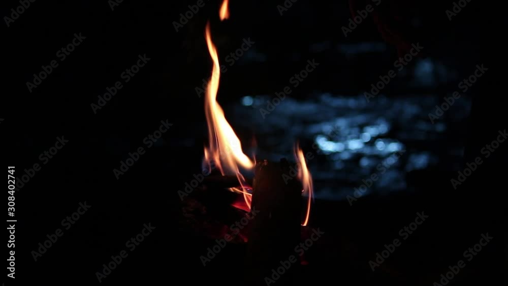 Burning red hot flying with sparks in the night sky. Beautiful abstract background of fire sparks particles on black background.