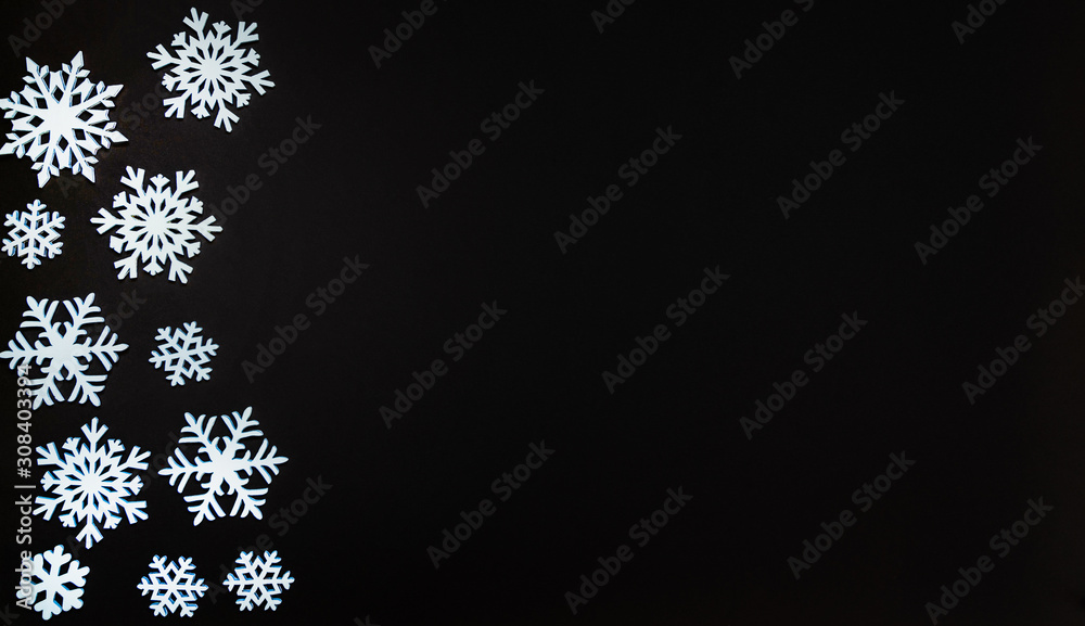 Christmas or winter composition. Frame made of snowflakes on dark background. Christmas, winter, new year concept. Flat lay, top view, copy space.