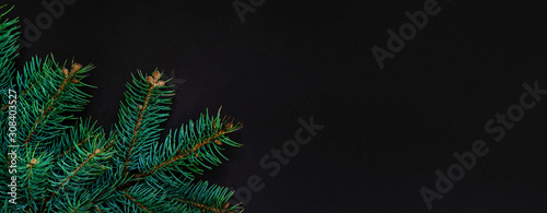 Christmas or New Year decoration background  fur-tree branches on dark grunge background with copy space. Nature New Year concept.