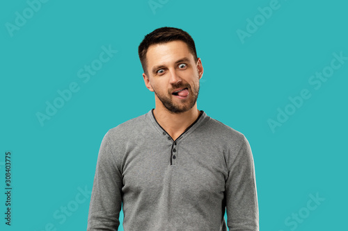 portrait of funny bearded man fooling around isolated on blue background.