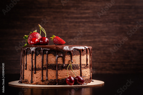 Leinwand Poster Chocolate cake with with berries, strawberries and cherries