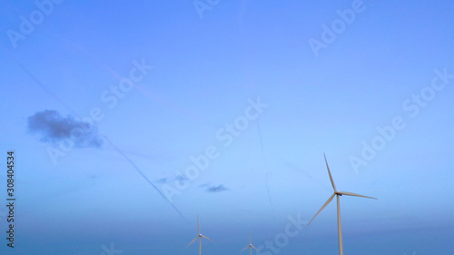 Wind turbine from aerial view - Sustainable development, environment friendly, renewable energy concept. Aerial View Of Wind Turbines In Blue Sky.