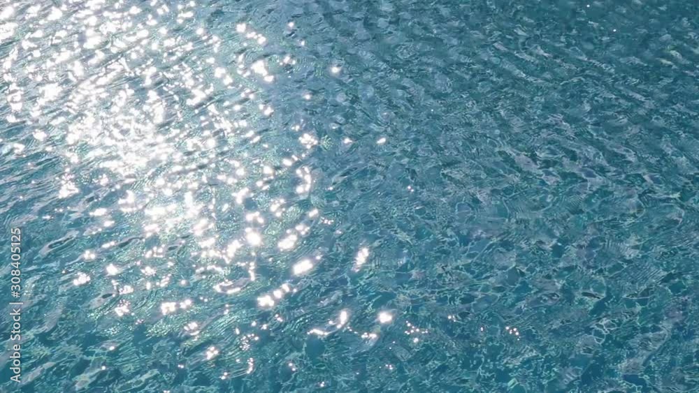 Water rippled pattern on blue water surface in swimming pool with sunlight reflected. Water rippled pattern on blue water surface in swimming pool with sunlight reflected.