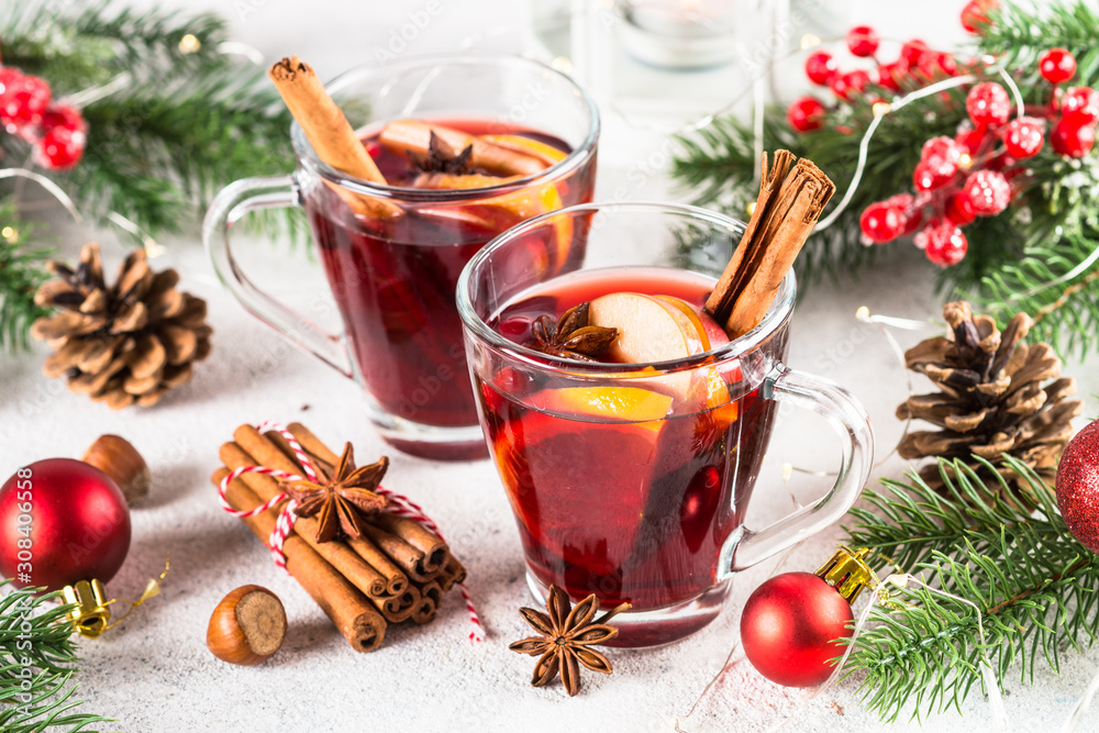 Mulled wine with christmas decorations on white.