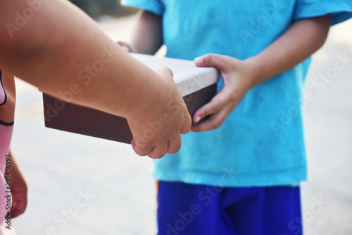 Hand giving gift box,Underprivileged children in Southeast Asia