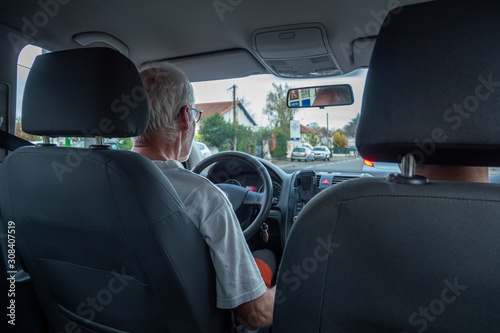 senior man driving car, wide angle interior view © Philipimage