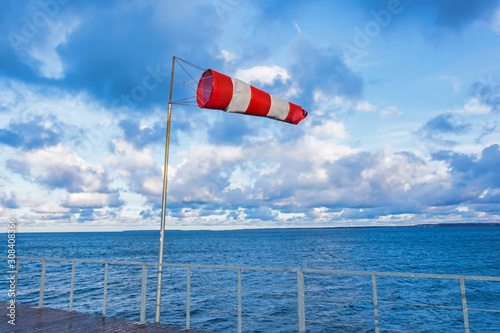 Windmill cone on a pier in a seaport in windy weather. photo