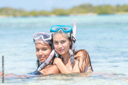 Beach vacation snorkel girl snorkeling with mask and fins. Bikini woman relaxing on summer tropical getaway doing snorkeling activity with snorkel tuba and flippers sun tanning. Caribbean destination. © GARSPHOTO