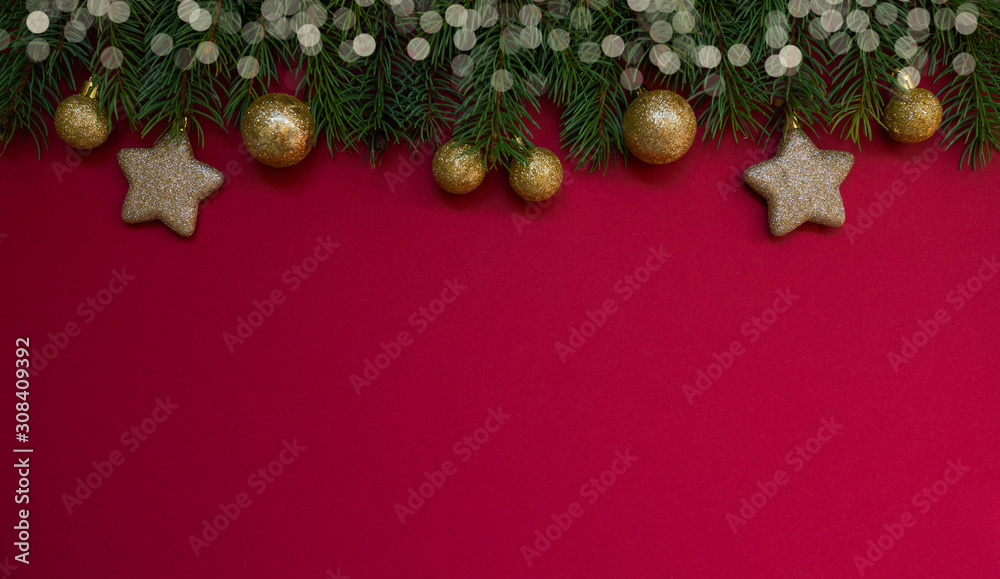 Christmas border. Fir branches and ornament on red background with copy space for your text. Christmas greeting card. Winter xmas holiday theme. Happy New Year. Christmas border. Fir branches and ornament on red background with copy space for your text. Christmas greeting card. Winter xmas holiday theme. Happy New Year.