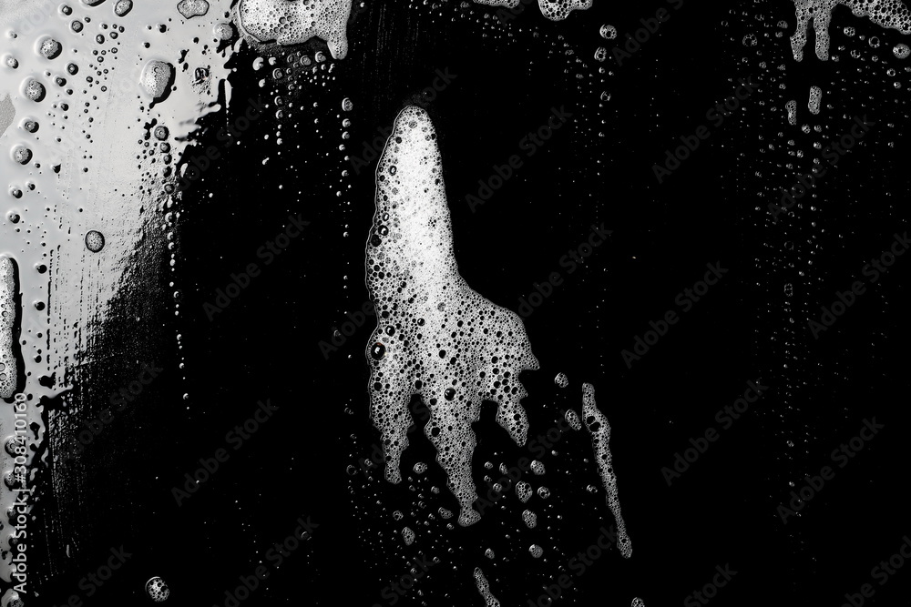 Obraz premium Soap foam, lather isolated on black surface with clipping path, texture and background, top view