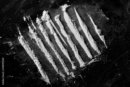 Cocaine lines isolated on black background, top view