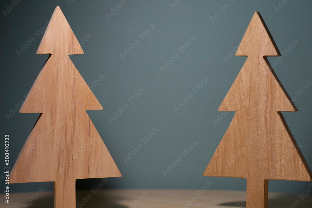 two Christmas trees on a grey background two Christmas trees on a grey background