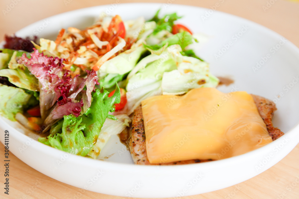 Grilled chicken steak with melted cheese and mixed salad Grilled chicken steak with melted cheese and mixed salad
