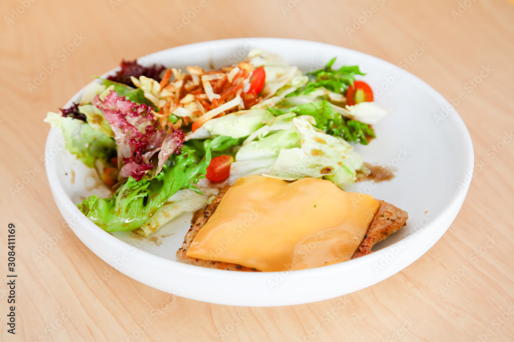 Grilled chicken steak with melted cheese and mixed salad Grilled chicken steak with melted cheese and mixed salad