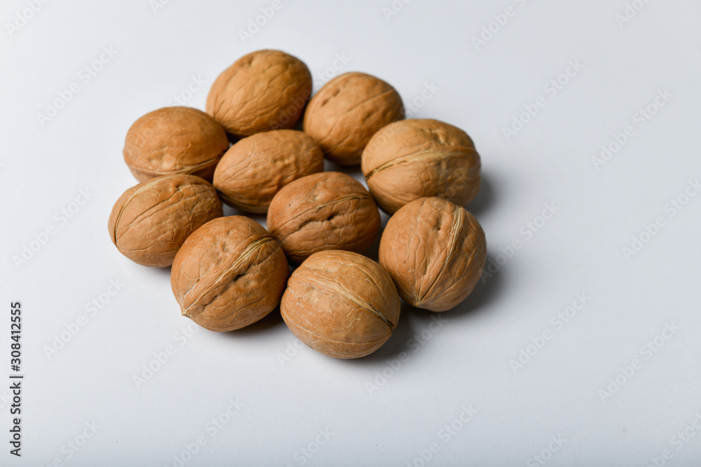 walnuts on a white background. Close up view of walnuts. Walnuts are 4 water, 15 protein, 65 fat and 14 carbohydrates, including 7 dietary fiber. In a reference portion of 100 grams. walnuts on a white background. Close up view of walnuts. Walnuts are 4 water, 15 protein, 65 fat and 14 carbohydrates, including 7 dietary fiber. In a reference portion of 100 grams.