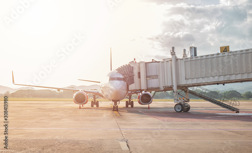 jet bridge or aerobridge connects the airplane’s door to the airport terminal, shelters for passengers disembark from an aircraft to the airport gate photo