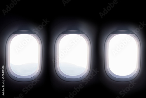 three airplane windows open white window shutter wide