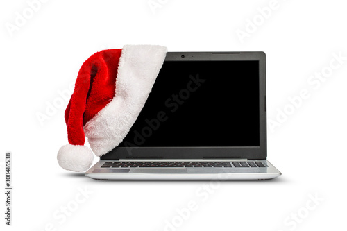 Laptop and Santa Claus hat on a white isolated background. Front view. Concept of buying gifts on the Internet. Christmas presents. The best choice