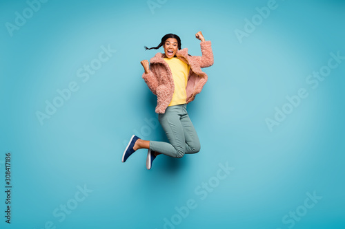 Fototapeta Naklejka Na Ścianę i Meble -  Full length body size view of nice attractive lovely overjoyed cheerful cheery girl jumping having fun celebrating isolated on bright vivid shine vibrant green blue turquoise color background